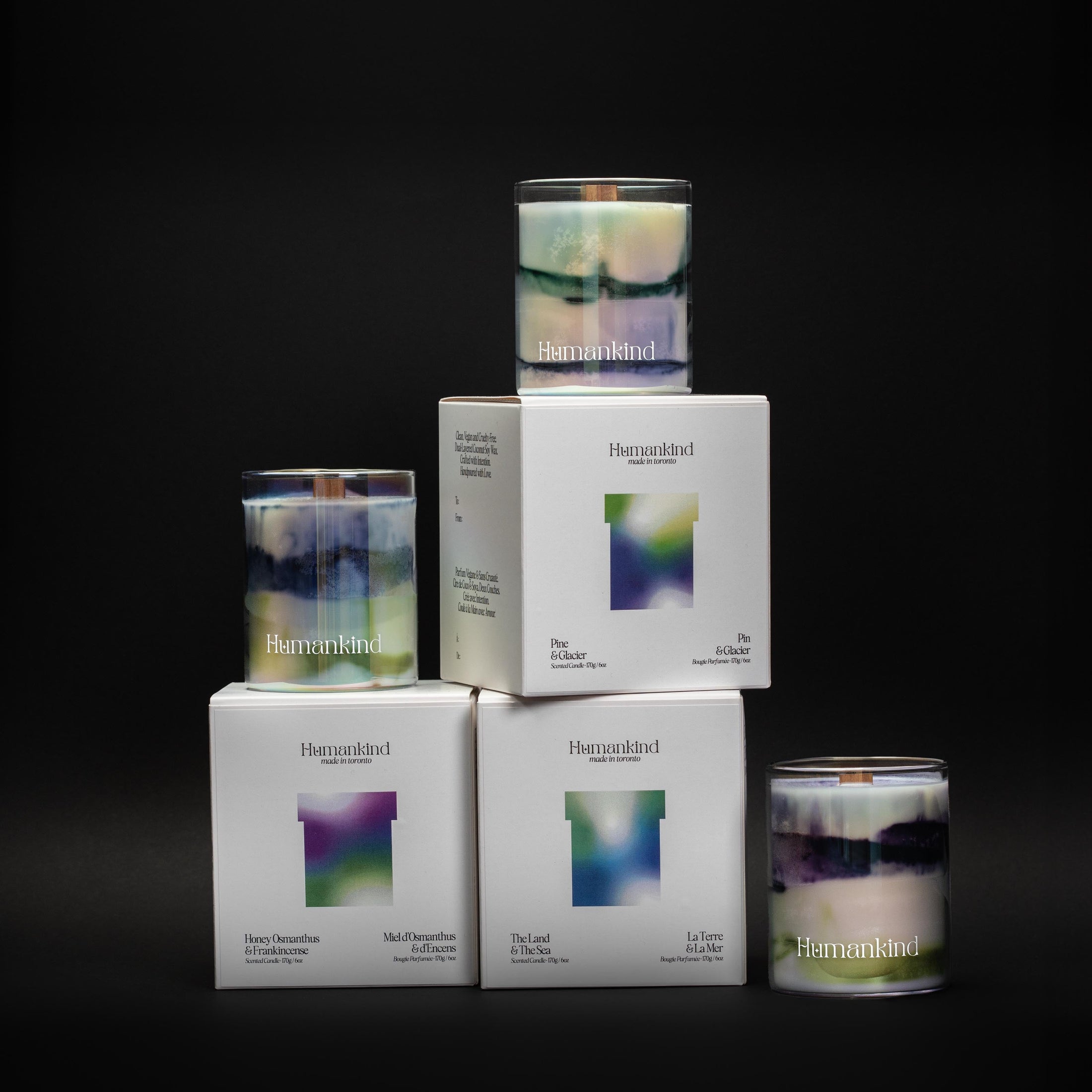 Candles and boxes with branding on a black background