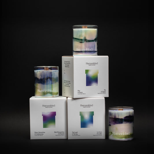 Candles and boxes with branding on a black background